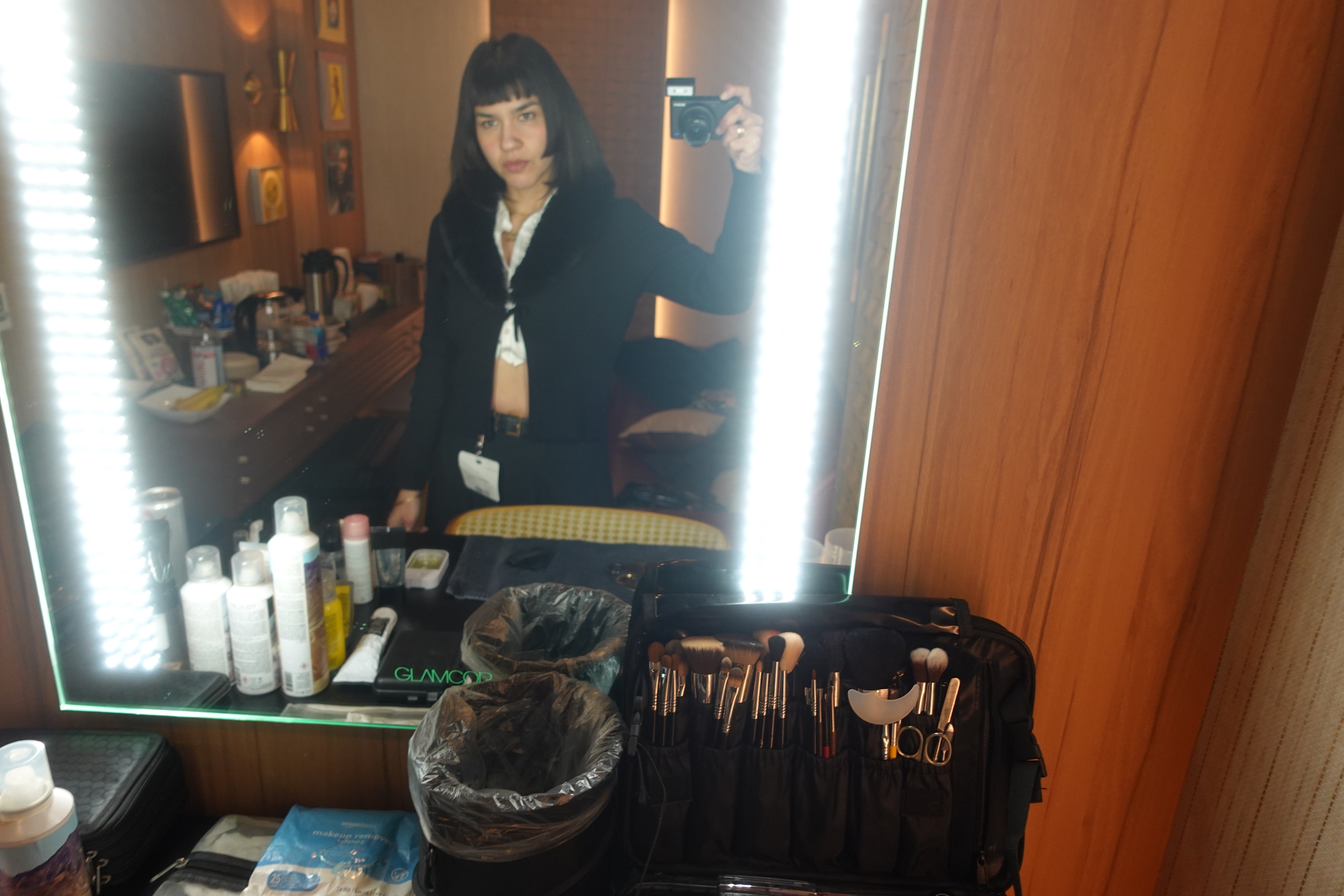 Leticia Llesmin, creative director, hair and makeup artist, and groomer, beside her professional kit.